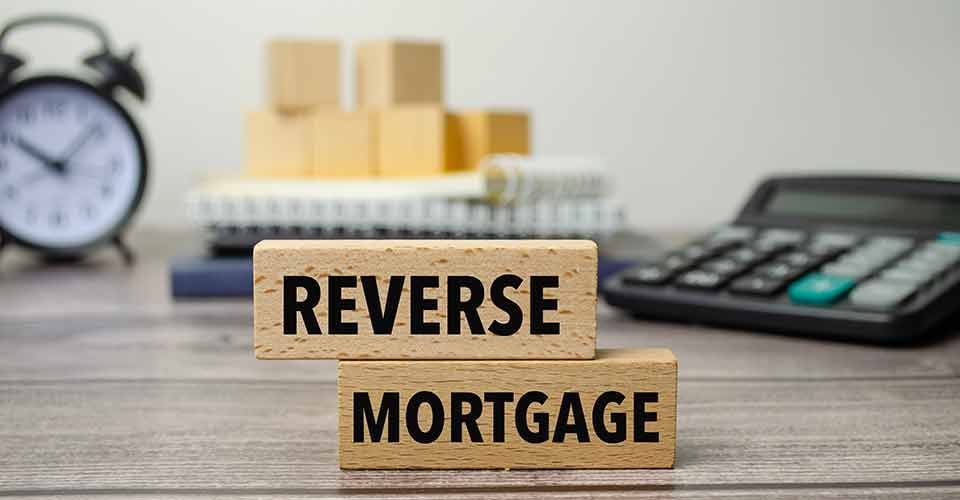Reverse Mortgage text written on wooden blocks lying on a table