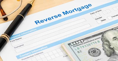 Reverse mortgage application form and dollar bills