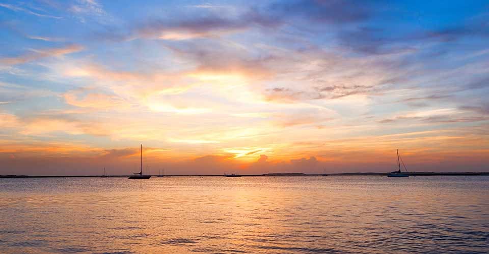 Sailing boat silhouette with sunset sky in Fernandina beach Florida