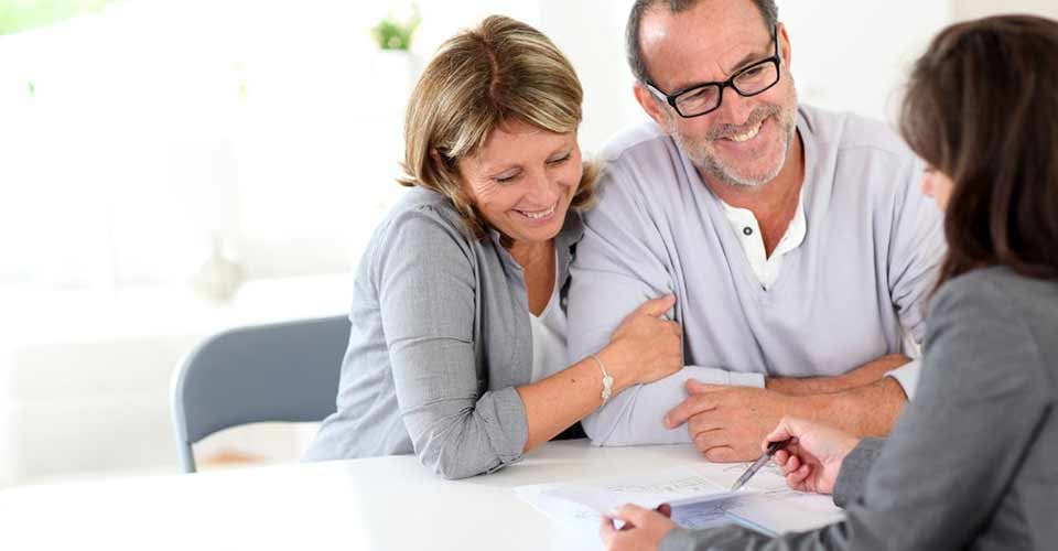 Senior couple signing financial contract