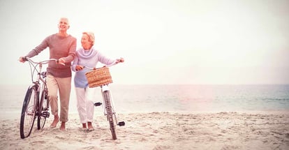 Senior couple with their bicycles at the beach