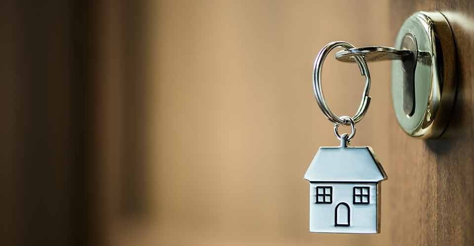 Silver house key in a door