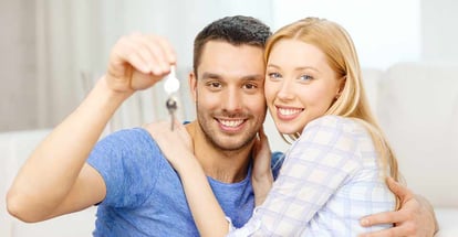 Smiling couple holding new house keys