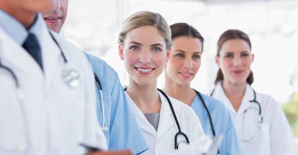 Smiling medical team in row in a hospital