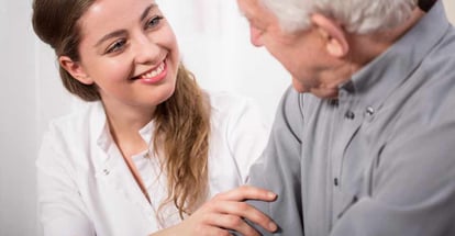 Smiling nurse assisting senior man