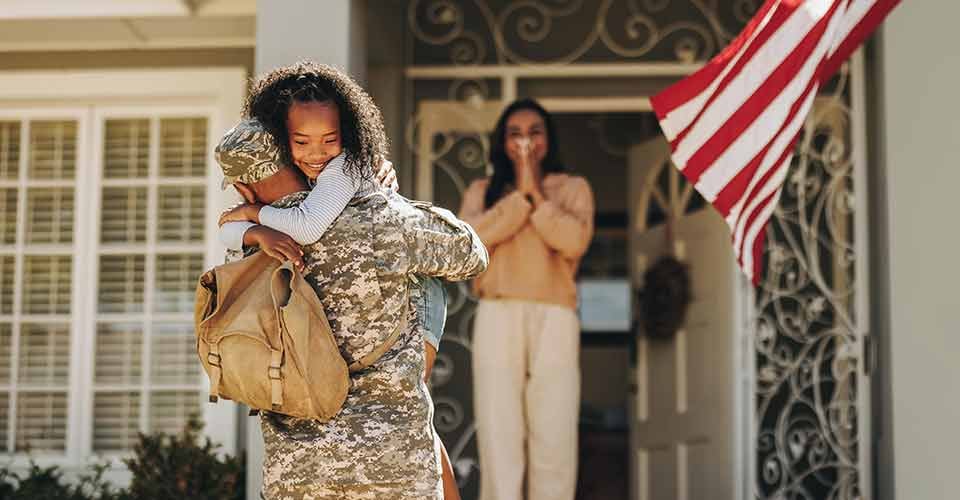 Soldier embracing his daughter after coming back home