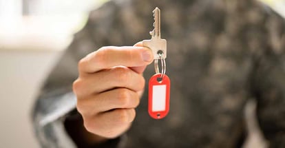 Soldier holding a key to new home after relocation