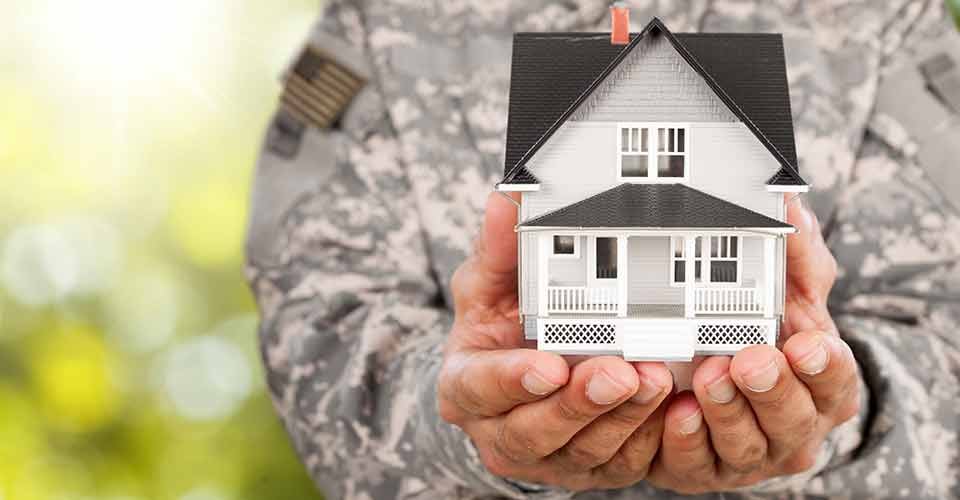Soldier holding a model house