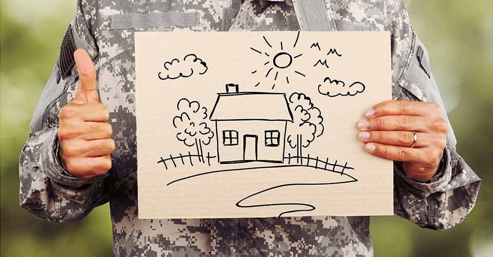 Soldier holding a paper sheet with house drawing