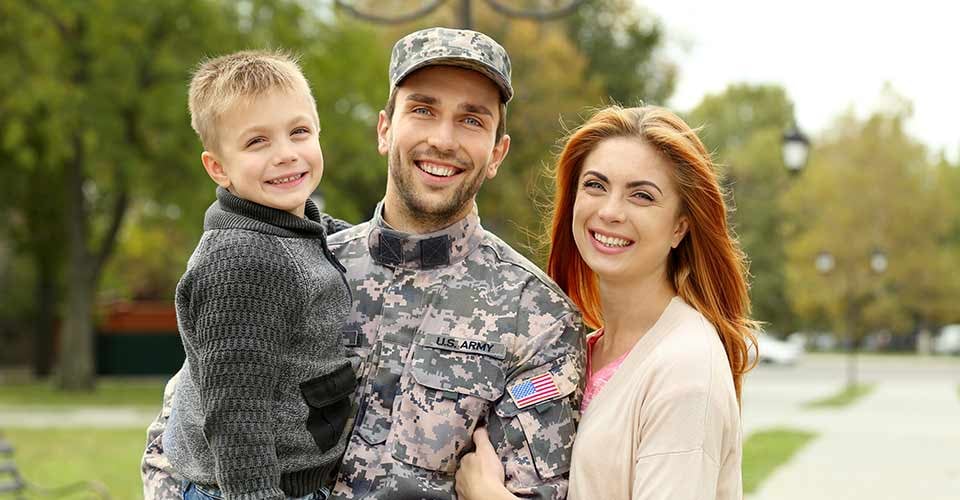Soldier with his family outside their home