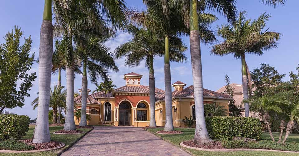 Southwest Florida concrete block and stucco home in the countryside with palm trees