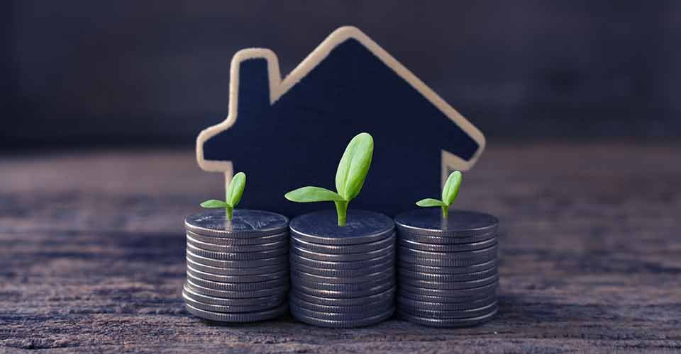 Stack-coins-and-house-wood-model-for-real-estate-investment