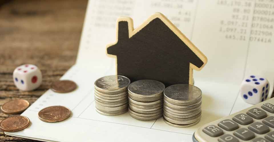 Stack coins and house wood model