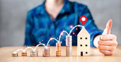 Stack of coins and model house