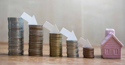 Stack of coins with house model