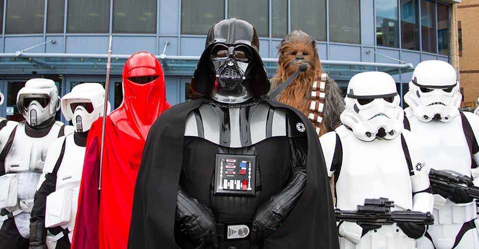Stormtroopers and Chewbacca lined up in formation