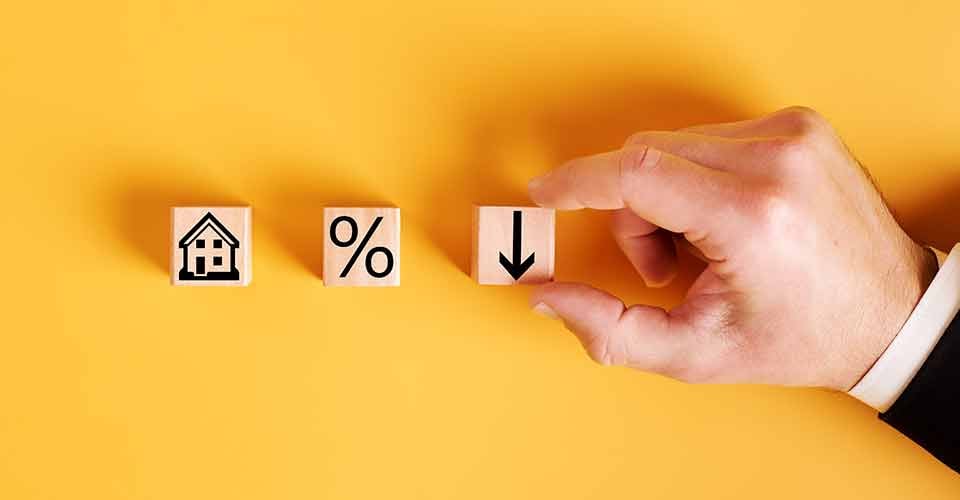Symbols house percent and down arrow on wooden cubes