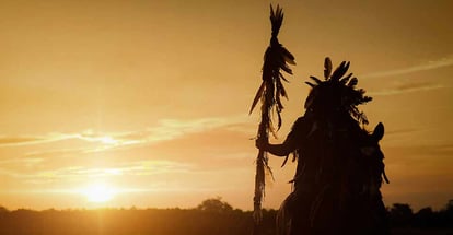 The Indians riding a horse with a spear in light of the Silhouette
