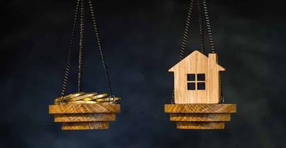 The scales with coins and model home