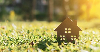 Tiny home model on green grass