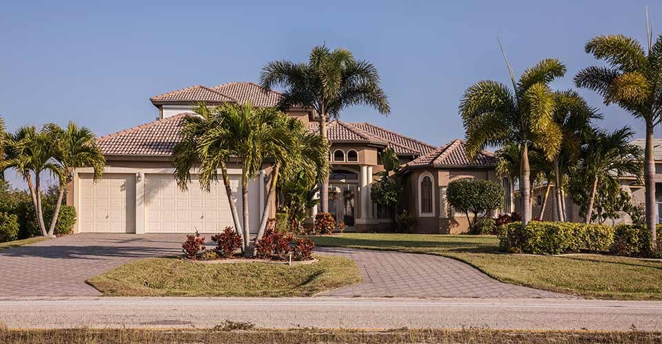 Typical Southwest Florida concrete block and stucco home with palm trees