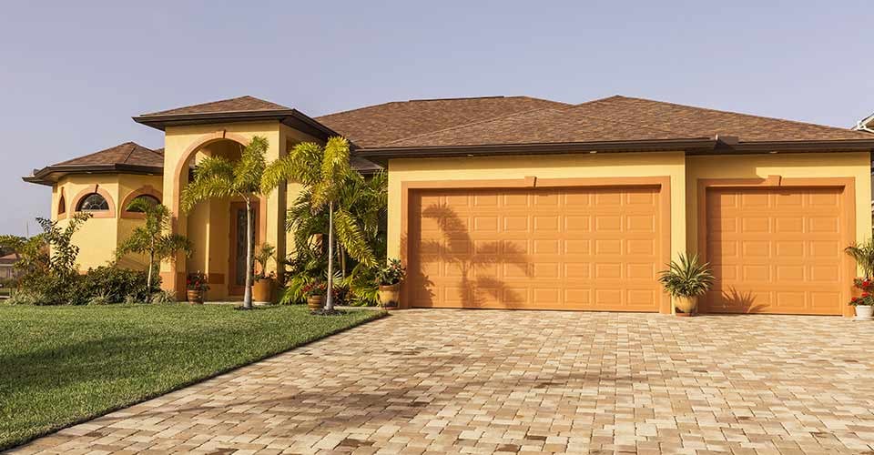 Typical concrete block and stucco home in the countryside with trees in Florida