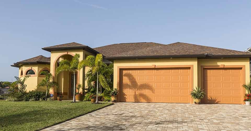 Typical concrete block and stucco home with palm trees in Southwest Florida