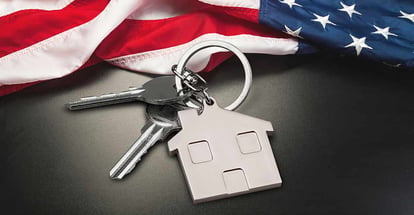 USA flag and key from home as symbol of VA loan on the desk