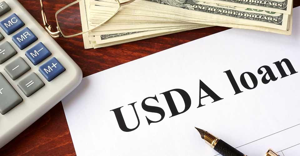 USDA loan form and documents on a table