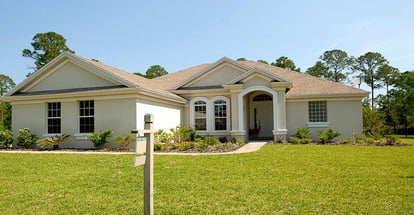 White and Brown Concrete Bungalow Under Clear Blue Sky in Florida