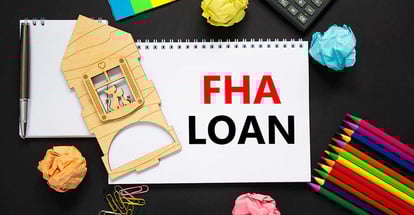 White note with words FHA loan on black background