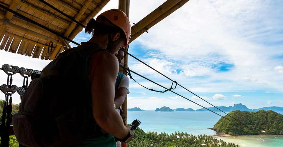 Wide angle view of tourist waiting to get the zipline