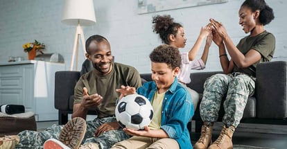 Woman and man in army uniform with their children enjoying time together