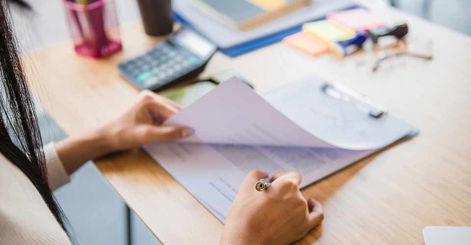Woman signing paperwork