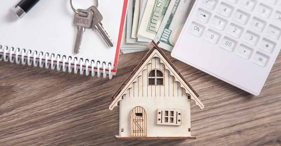 Wooden house model with a keys and calculator
