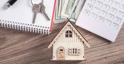 Wooden house model with a keys and calculator