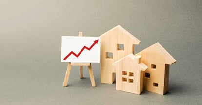 Wooden houses and red up arrow on the board