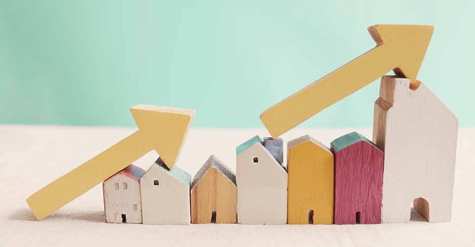 Wooden houses with yellow arrows up
