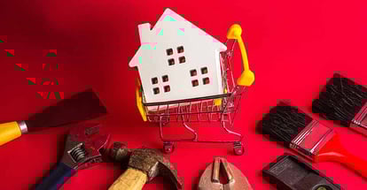 Wooden white house model and construction tools for home renovation