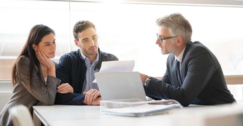 Young couple meeting financial advisor for home investment