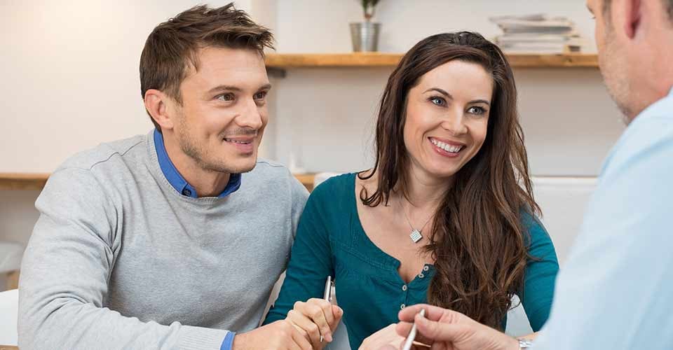 Young couple meeting loan officer for mortgage program