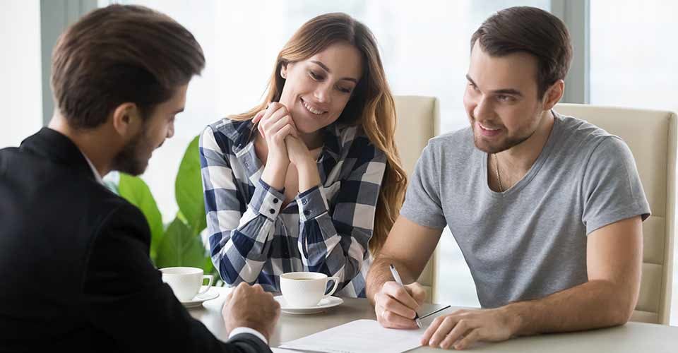 Young couple signs contract with realtor