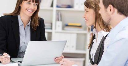 Young couple sitting in an office talking to a investment adviser