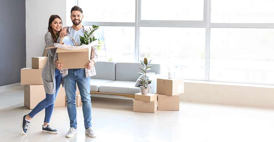Young couple with belongings in their new house in Florida