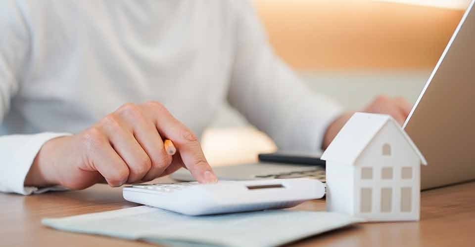 Young man use calculator for home equity