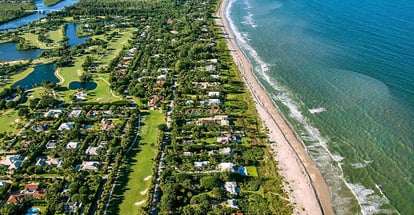 Aerial view of Florida along the Atlantic Ocean coast lined by the beach and luxury homes