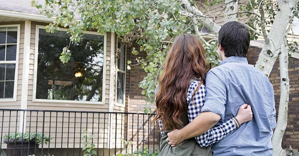 Homeowner couple outside new home