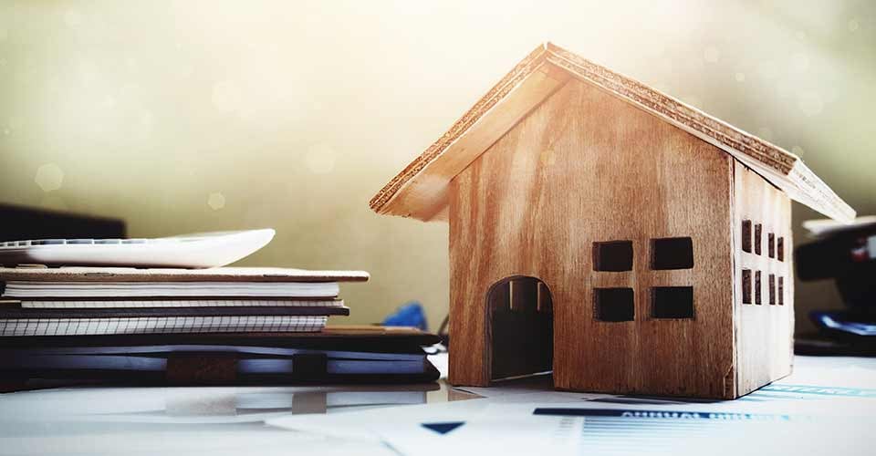 Wood house toy on office desk