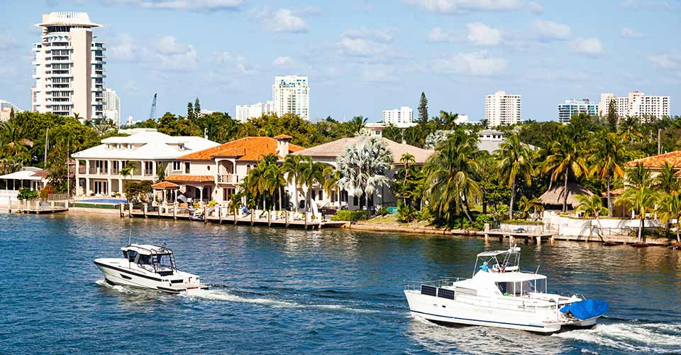 Bay and coastline in clear sunny weather with luxury homes and yachts