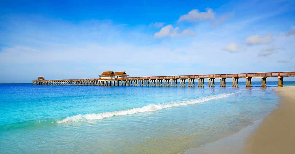 Naples Pier and beach on sunny day in Florida